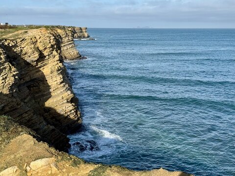 Beach view in Peniche, Portugal. High clifs and crushing waves 
