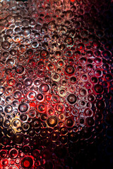  textured glass background. circles pattern in pink and red tones.multicolored light in circles background.Circle wallpaper. Textured wall with light .