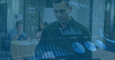 Image of financial data processing over caucasian businessman using tablet in office