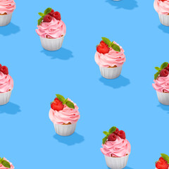 Pattern of cupcakes with berries on blue background