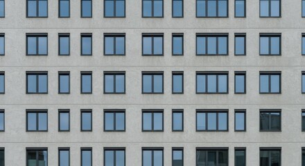 Obraz premium Urban building facade. Seamless pattern of a modern residential structure with rows of identical windows and a textured exterior