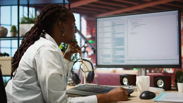 Irked software developer frustrated while coding, struggling to implement algorithms. Unhappy IT expert annoyed while working with code editor, unable to optimize performance, camera A