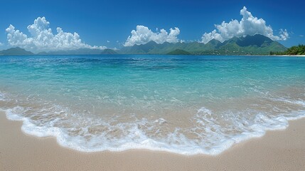 Stunning tropical beach with clear turquoise water and gentle waves under a bright sky