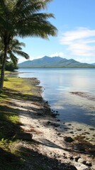 Tropical beach, calm ocean, mountain backdrop, sunny day, idyllic vacation scene
