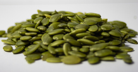 Close up pile of pumpkin seeds ,isolated. White background. Healthy food.Healthy food. Vegan food concept .Source of vitamins and minerals