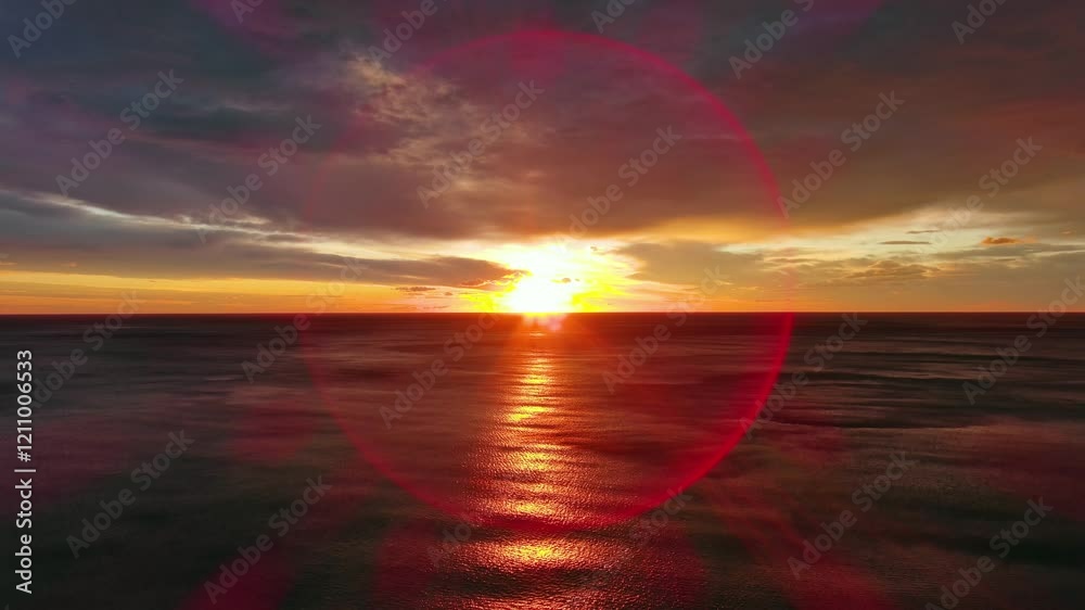 Wall mural aerial view of sea surface during a dramatic red sunset, 4k