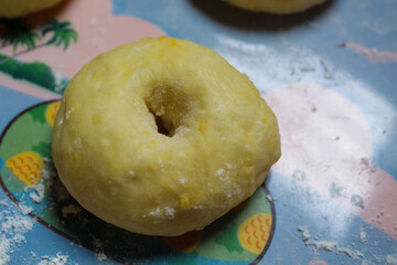 Donut dough that has been shaped and waiting to rise, proofing process