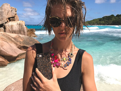 Girl on the beach with luxury accessoires
