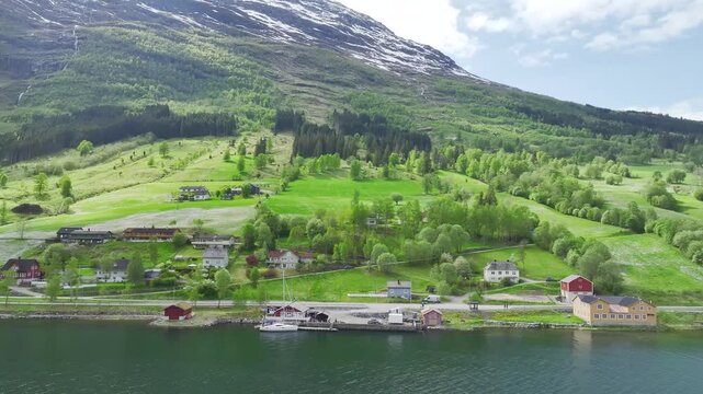 Mountains and Fiord in the clouds over Village from a drone, Olden, Innvikfjorden, Norway