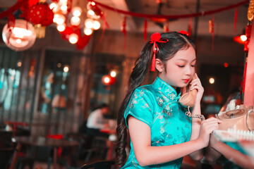 Girl celebrating chinese new year in a cozy restaurant setting