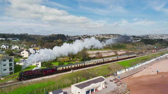 Steam Train over Goodrington Beach from a drone, Paignton, Kingswear, Devon, England