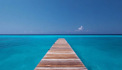 Obraz premium Serene wooden pier extending into clear blue ocean waters.
