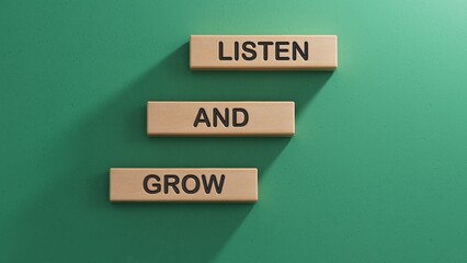 Listen and grow symbol. Concept words Listen and grow on wooden blocks.Business and Listen and grow concept. Copy space.3D rendering on green background.