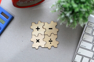 jigsaw puzzle with plus, minus, multiplication and division symbols. Four Basic Mathematical Operations. Addition, Subtraction, multiplication, division.