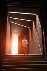 Soft focus of man in the tunnel with sunlight background .light at the end of the tunnel offers a...