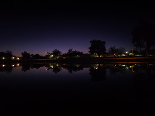 Sunset over a lake and a park