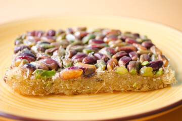 Pistachio and Honey Coated baklava on Yellow Decorative Plate