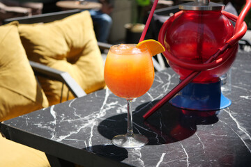 Enjoying a Refreshing Tropical Cocktail Placed on a Stylish Outdoor Table