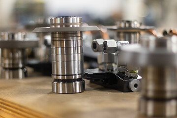 Shiny metal machine tools like chrome in a manufacturing shop.