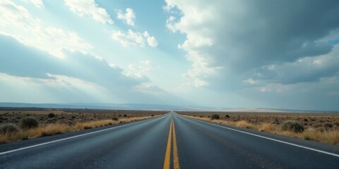 Naklejka premium Asphalt Ribbon Unfolding Towards a Serene Horizon Under a Vast and Dramatic Sky