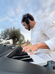 Boy Plays Keyboard In Nature In Calabria Countryside
