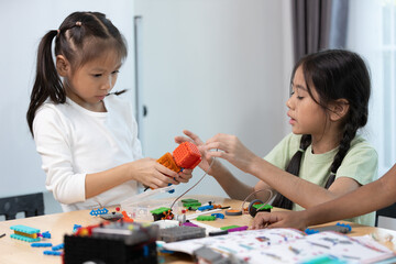 Fototapeta premium Education STEM children student in classroom. Robot assembly training, brain development, Learning electrical future engineering.