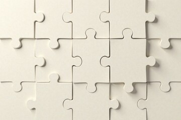 Cream-colored jigsaw puzzle pieces interlock, representing unity and collaborative problem-solving in a business or team setting