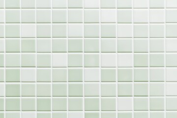 A close-up view of a light green tile mosaic, featuring small square tiles arranged in a neat, repeating pattern.