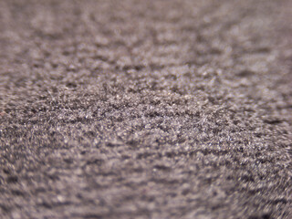 A close up of a carpet with a grainy texture