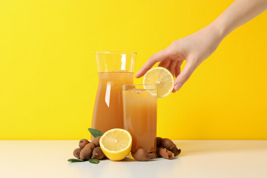 Tamarind juice in a glass with an orange