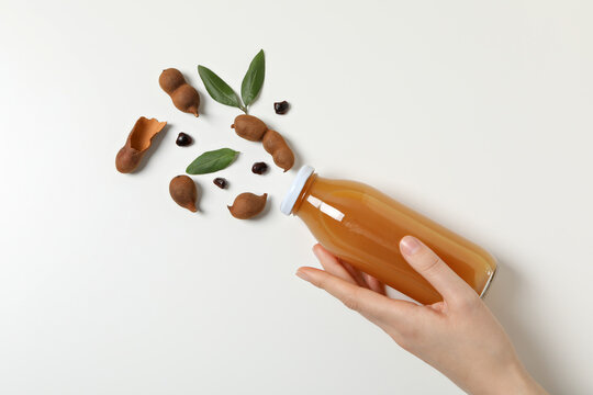 Tamarind juice in a glass bottle on a light background