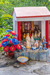 An altar with a Buddhist god outside a pagoda in Asia.