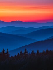 Obraz premium Dusk sky over blue mountains with tree silhouettes, red and orange sunset, minimal nature