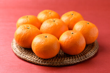 Mandarin tangerine orange fruit on red background, Lucky food in Lunar New Year or Chinese New Year
