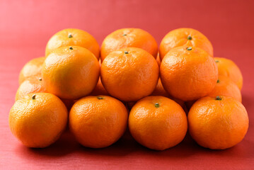Mandarin tangerine orange fruit on red background, Lucky food in Lunar New Year or Chinese New Year