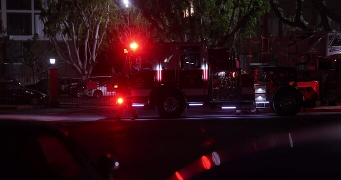 A fire engine responds to the scene of an emergency at night.
