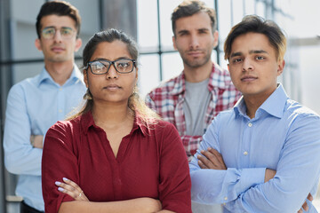 Obraz premium Excited to hear your project requirements. a diverse group of businesspeople standing with their arms crossed in the office.