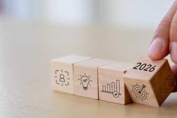 2026 Strategic planning, business goals and achievement concept. Flipping wooden blocks with icons...