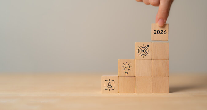 2026 Strategic planning, business goals and achievement concept. Wooden blocks with icons representing human resource development, innovation and target achievement. Business growth strategy.