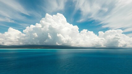 tropical beach with turquoise water and white clouds in the blue sky