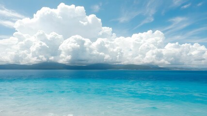tropical beach with turquoise water and white clouds in the blue sky