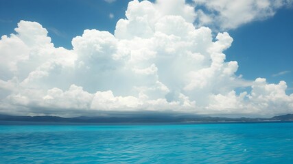 tropical beach with turquoise water and white clouds in the blue sky
