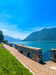View of Iseo Lake Surrounded by Majestic Mountains and Clear Blue Skies, Italy