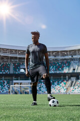 feet of soccer player tread on soccer ball in the stadium