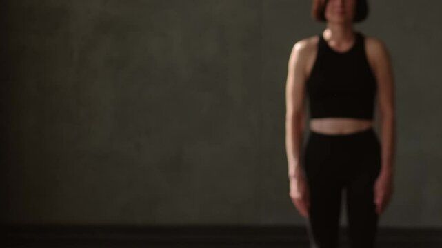 Athletic lifestyle. Aerobic workout. Active people stepping barefoot on sport mat before star pilates class training session with female fitness coach in gym studio indoors.