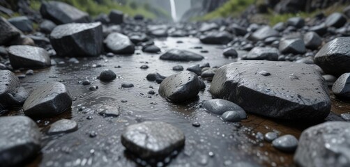 Obraz premium Droplets of water strike wet, grey stones in a rocky environment , rocky terrain, grey stone