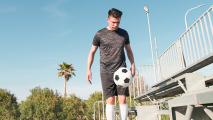 Neighborhood Boy Sitting In The Stands With The Soccer Ball In His Hand