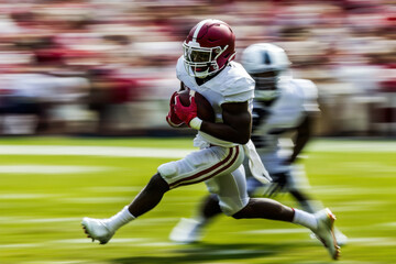 Dynamic image of a football player spinning away from a tackle attempt