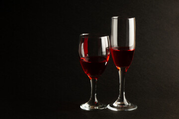 Negative Space displays different sized red wine glasses on a black background, perfect for adding romantic text.