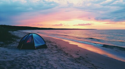 A tent pitched on a sandy beach, with gentle waves and a colorful sunset in the background.